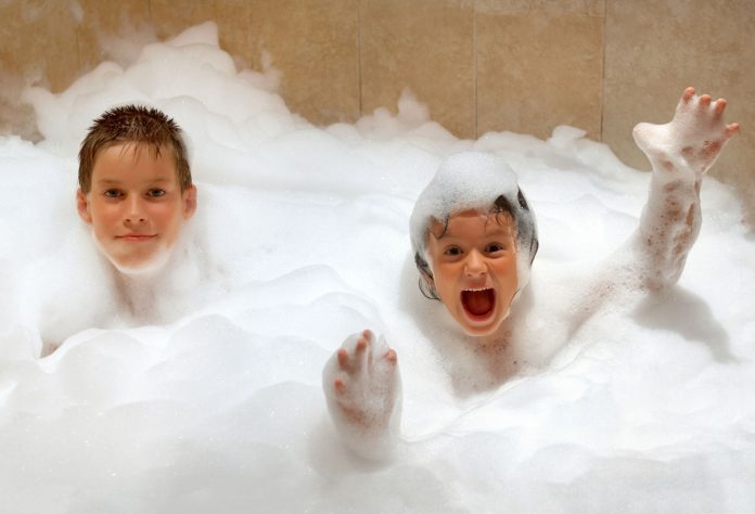 Kids enjoying heat pump hot water available with STC Rebates