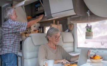 Grey nomads planning their day over breakfast while caravanning Queensland