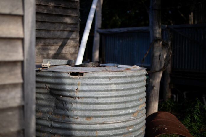 Rusty and dented steel tank. Replace rainwater tank when it is in poor condition.