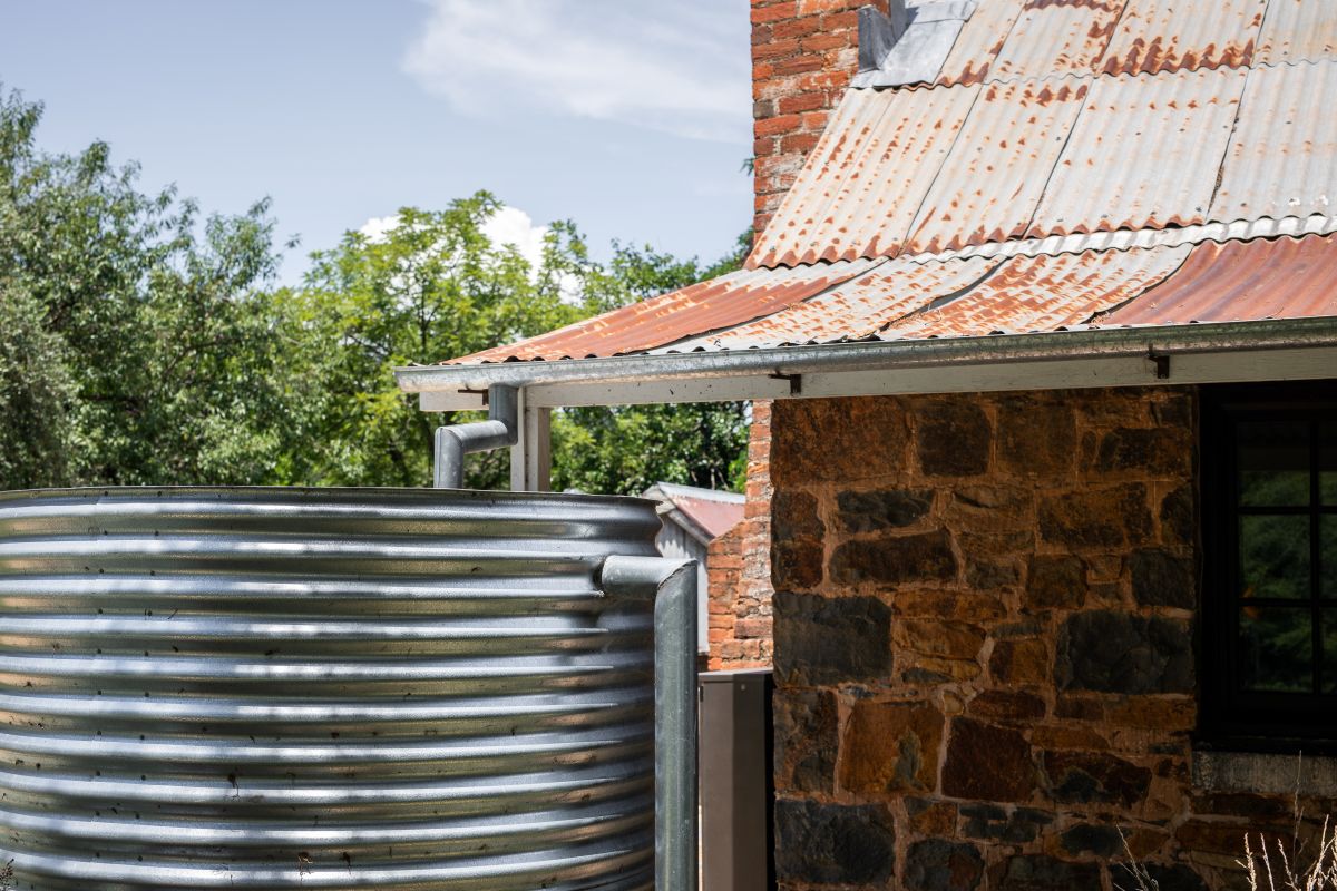 Replacement rainwater tank installed and connected to house.